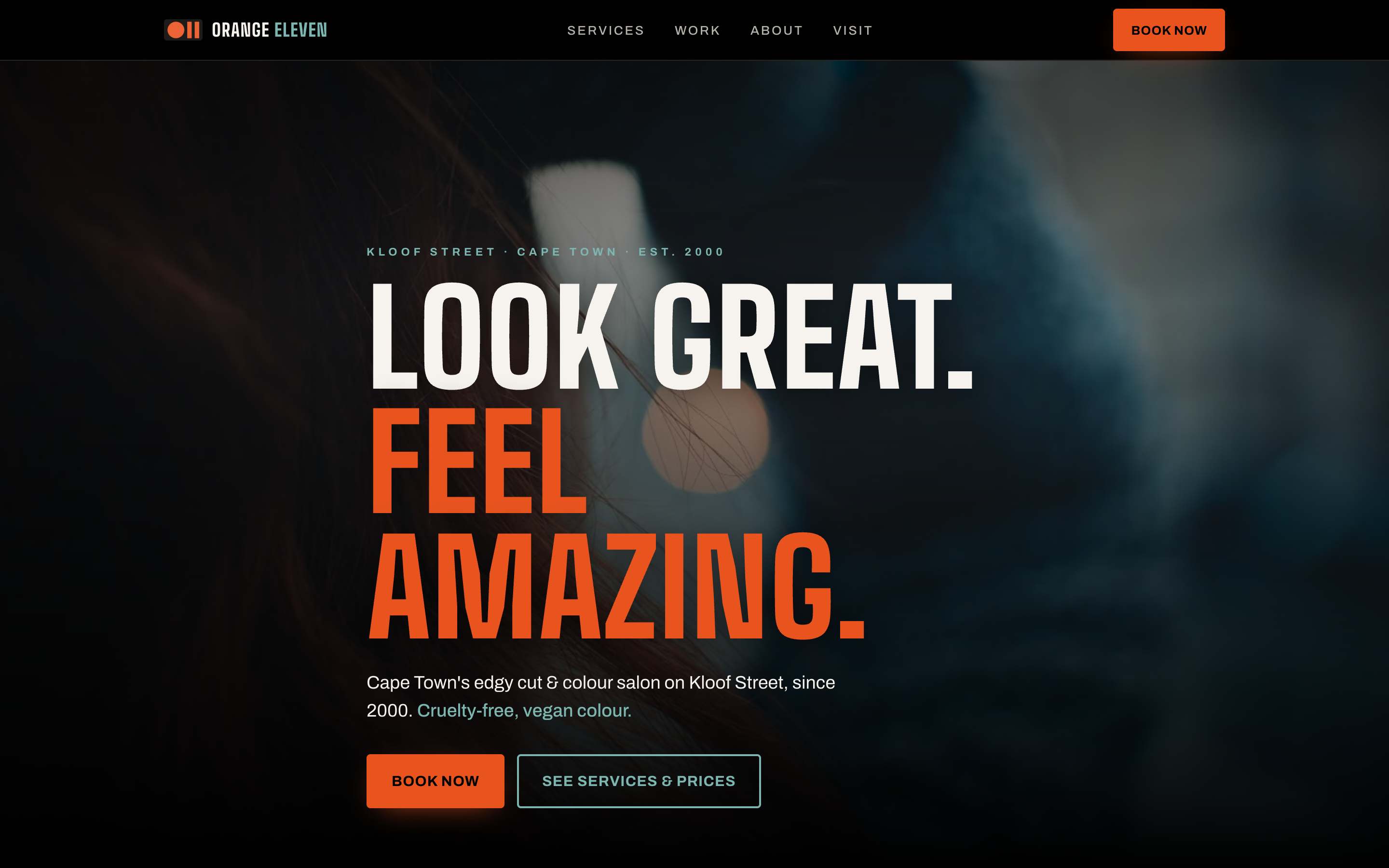 The Orange Eleven salon homepage: the headline “Look Great. Feel Amazing.” over a dark cut-and-colour photograph, with Book Now in the header and again under the headline.